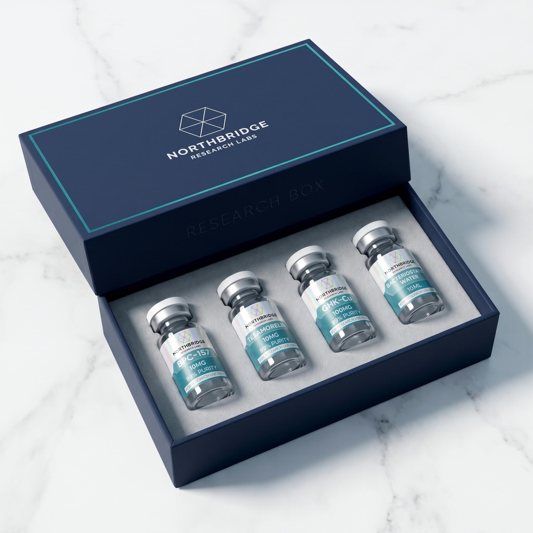 The Research Box, open: three research vials and a bacteriostatic water nested in foam inside a navy presentation box